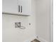 White laundry room with upper cabinets, utility hookups and white trim at 397 Parkdale Dr, Charleston, SC 29414