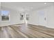 Sun-filled living room with wood-look flooring, white walls, recessed lighting, and two large windows at 397 Parkdale Dr, Charleston, SC 29414