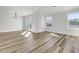 Open living room with chandelier, wood-look floors, white walls, and a french door with natural light at 397 Parkdale Dr, Charleston, SC 29414