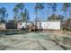 The home exterior showcases a newly seeded lawn and a small wooden deck with stairs at 421 Peacock Ln, Summerville, SC 29486