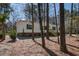 Picturesque single-story home with white siding, dark shutters, wooden stairs, and a natural wooded setting at 421 Peacock Ln, Summerville, SC 29486