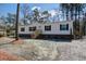 Inviting single-story home with wooden stairs, vinyl siding, dark shutters, and a gravel and pine straw yard at 421 Peacock Ln, Summerville, SC 29486