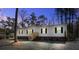 Charming single-story home featuring white siding, dark shutters, brick skirting, and wooden entry stairs at 421 Peacock Ln, Summerville, SC 29486