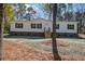 Well-maintained white single-story home with black shutters, wooden steps, and a freshly mulched yard at 421 Peacock Ln, Summerville, SC 29486