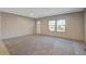 Bright and airy living room with new carpet and neutral walls, showcasing ample natural light at 421 Peacock Ln, Summerville, SC 29486