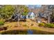Beautiful view of the home from above, surrounded by lush landscaping and pond at 4333 Cloudmont Dr, Hollywood, SC 29449