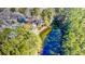 Aerial perspective of a waterway near a house bordered by vibrant trees and lush landscaping at 4333 Cloudmont Dr, Hollywood, SC 29449