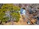 Aerial view of house with large windows, nestled among lush trees, showing the backyard shed at 4333 Cloudmont Dr, Hollywood, SC 29449