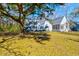 Expansive backyard featuring mature trees and lush landscaping surrounding the charming home at 4333 Cloudmont Dr, Hollywood, SC 29449