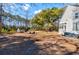 A huge backyard with a shed and two chairs sitting near each other, trees surrounding at 4333 Cloudmont Dr, Hollywood, SC 29449