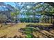 Expansive backyard featuring lush greenery, a serene shed, and tranquil views of the surrounding nature and a relaxing place to sit at 4333 Cloudmont Dr, Hollywood, SC 29449