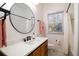 Modern bathroom vanity and sink with black fixtures, round mirror, and shower at 4333 Cloudmont Dr, Hollywood, SC 29449