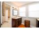 Bright bathroom featuring dark wood cabinets, wood floors, and plenty of natural light at 4333 Cloudmont Dr, Hollywood, SC 29449