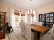 Charming dining room with a wooden table, stylish chandelier, and large windows at 4333 Cloudmont Dr, Hollywood, SC 29449