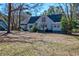 Charming two-story home with light blue siding nestled among mature trees and a bright blue sky at 4333 Cloudmont Dr, Hollywood, SC 29449