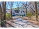 Two-story home with light blue siding with lots of trees lining the driveway at 4333 Cloudmont Dr, Hollywood, SC 29449