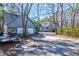 A large two car garage with upper level access and a light blue facade, with additional homes nearby at 4333 Cloudmont Dr, Hollywood, SC 29449