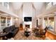 Bright open concept living room with vaulted ceiling, fireplace, and large windows at 4333 Cloudmont Dr, Hollywood, SC 29449
