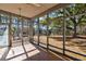 Enclosed porch overlooking the picturesque backyard and mature trees at 4333 Cloudmont Dr, Hollywood, SC 29449
