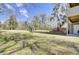 Spacious backyard with water view and mature trees is perfect for outdoor recreation and relaxation at 4610 Palm View Cir, North Charleston, SC 29418