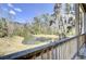 Tranquil backyard view overlooking a serene pond with mature trees and lush greenery at 4610 Palm View Cir, North Charleston, SC 29418