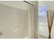 Bathroom with a bathtub and shower, neutral paint color, and great natural light from the window at 4610 Palm View Cir, North Charleston, SC 29418