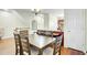 Dining room with hardwood floors, seating for six, and views of the kitchen and staircase at 4610 Palm View Cir, North Charleston, SC 29418