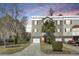 A charming multi-story townhome with a driveway and lush landscaping at 4610 Palm View Cir, North Charleston, SC 29418