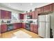 Bright kitchen with stainless steel appliances and cherry wood cabinets, ready for culinary adventures at 4610 Palm View Cir, North Charleston, SC 29418