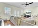 Cozy living room with a large gray sectional sofa, hardwood floors, and plantation shutters at 4610 Palm View Cir, North Charleston, SC 29418