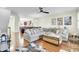 Open-concept living room with hardwood floors, a large sectional sofa, and views of the kitchen at 4610 Palm View Cir, North Charleston, SC 29418