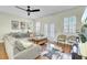 Spacious living room features a large gray sectional sofa, hardwood floors, and plantation shutters at 4610 Palm View Cir, North Charleston, SC 29418