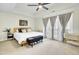 Main bedroom with tray ceiling, ceiling fan, and light neutral carpet at 4610 Palm View Cir, North Charleston, SC 29418