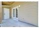Concrete patio with room for outdoor seating and access to the home through a set of glass doors at 4610 Palm View Cir, North Charleston, SC 29418