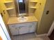 Bathroom featuring a vanity with a sink and storage, a framed mirror, and corner shelves at 4829 Hillock Ave, North Charleston, SC 29418