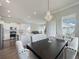 Dining area open to modern kitchen, with a stylish chandelier, comfortable seating, and sliding glass door at 500 W Respite Ln, Summerville, SC 29483