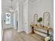 Inviting entrance hallway with modern light fixture, featuring a decorative table, and stylish flooring at 500 W Respite Ln, Summerville, SC 29483