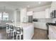 Bright kitchen features an island with seating, stainless steel appliances, and white cabinets at 500 W Respite Ln, Summerville, SC 29483