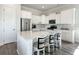 Modern kitchen with white cabinets, stainless steel appliances, an island, and stylish bar stools at 500 W Respite Ln, Summerville, SC 29483