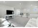 Spacious living room with gray carpet, white walls, and large screen television for comfortable viewing at 500 W Respite Ln, Summerville, SC 29483