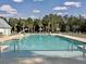 Community swimming pool with ample seating and palm trees at 500 W Respite Ln, Summerville, SC 29483