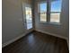 Room with wood-look floors, a door and double windows with exterior views at 5118 Double Eagle Lp, Summerville, SC 29485