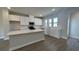 Open kitchen boasts white cabinets, stainless steel appliances, and a large island at 5118 Double Eagle Lp, Summerville, SC 29485