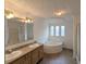 Bathroom featuring a double vanity, soaking tub with tile surround, and a shower at 5181 Dr Taylor Rd, Adams Run, SC 29426