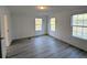 Bright bedroom with neutral walls, wood-look floors, and dual windows for natural light at 5181 Dr Taylor Rd, Adams Run, SC 29426