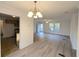 Spacious living room featuring bright light-colored floors, white walls, and views to the entry and kitchen at 5181 Dr Taylor Rd, Adams Run, SC 29426