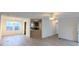 Bright living room featuring light-colored vinyl floors, white walls, and an open floor plan at 5181 Dr Taylor Rd, Adams Run, SC 29426
