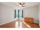 Bright bedroom with hardwood flooring, two windows, and a wooden dresser at 5429 Roxbury Dr, North Charleston, SC 29418