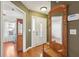Entryway featuring hardwood floors, a coat rack and mirror, and a view into adjacent rooms at 5429 Roxbury Dr, North Charleston, SC 29418