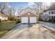 A spacious two-car garage is adjacent to a brick veneer exterior and a large concrete driveway at 5429 Roxbury Dr, North Charleston, SC 29418